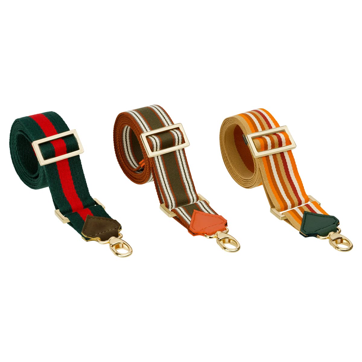 Abgebildet sind drei gerollte, verstellbare Clutch "Paris/Cortina" (Racing-Green) Taschenriemen mit goldenen Beschlägen, die ein Streifenmuster in Grün-Rot, Grün-Braun-Weiß und Orange-Weiß-Gelb aufweisen.